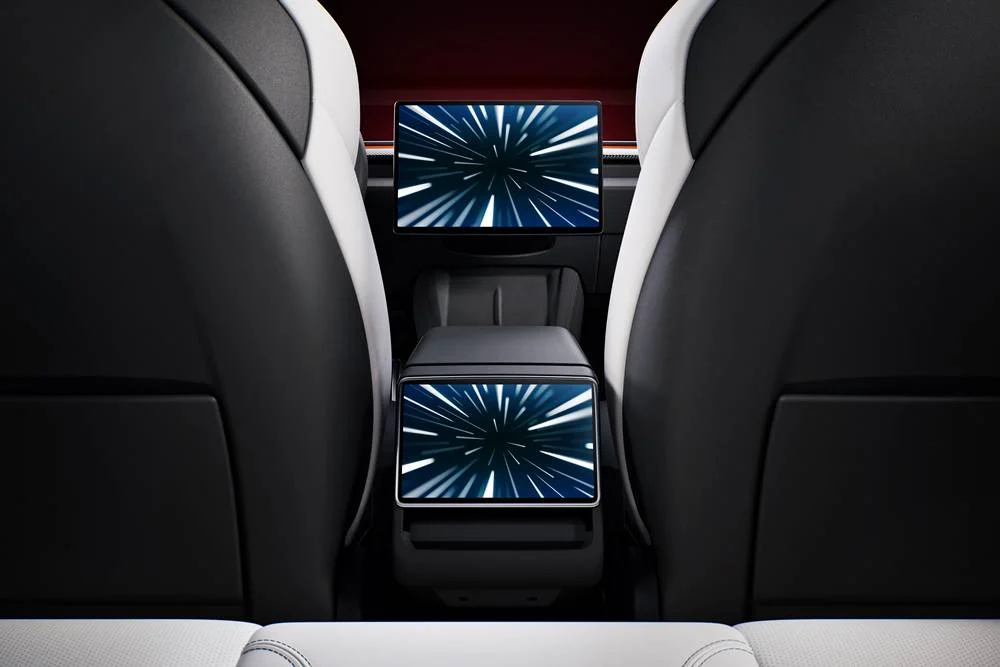 Rear interior view of a Tesla Model 3 Performance showing two screens on the centre console.