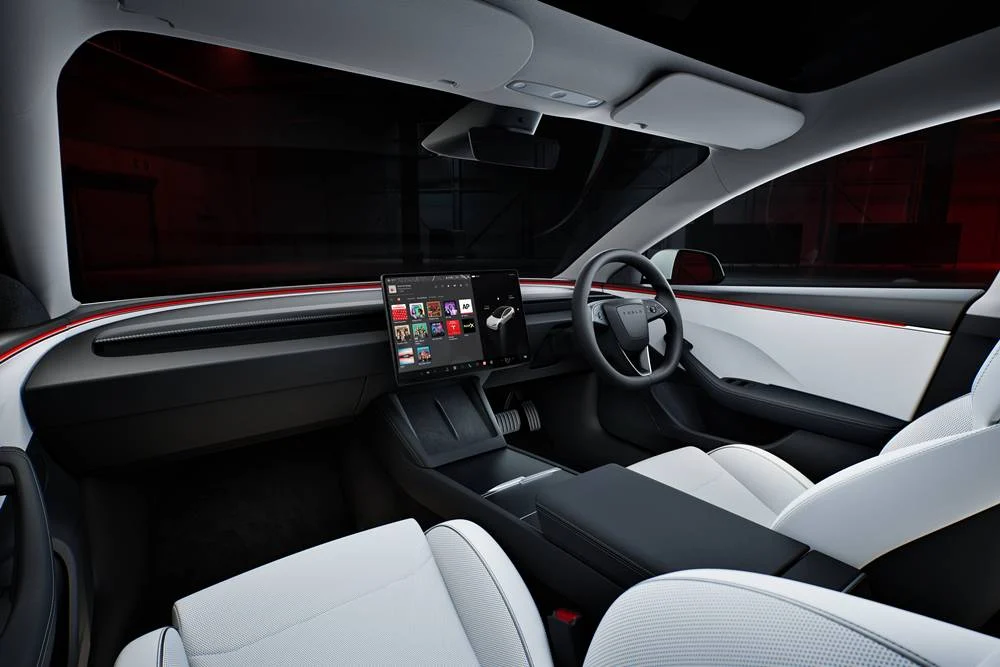 Rear interior view of a Tesla Model 3 Performance showing two screens on the centre console.