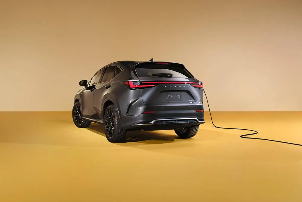 lexus-2026-nx450h-plus-from the rear showing rear and side while charging 3/4