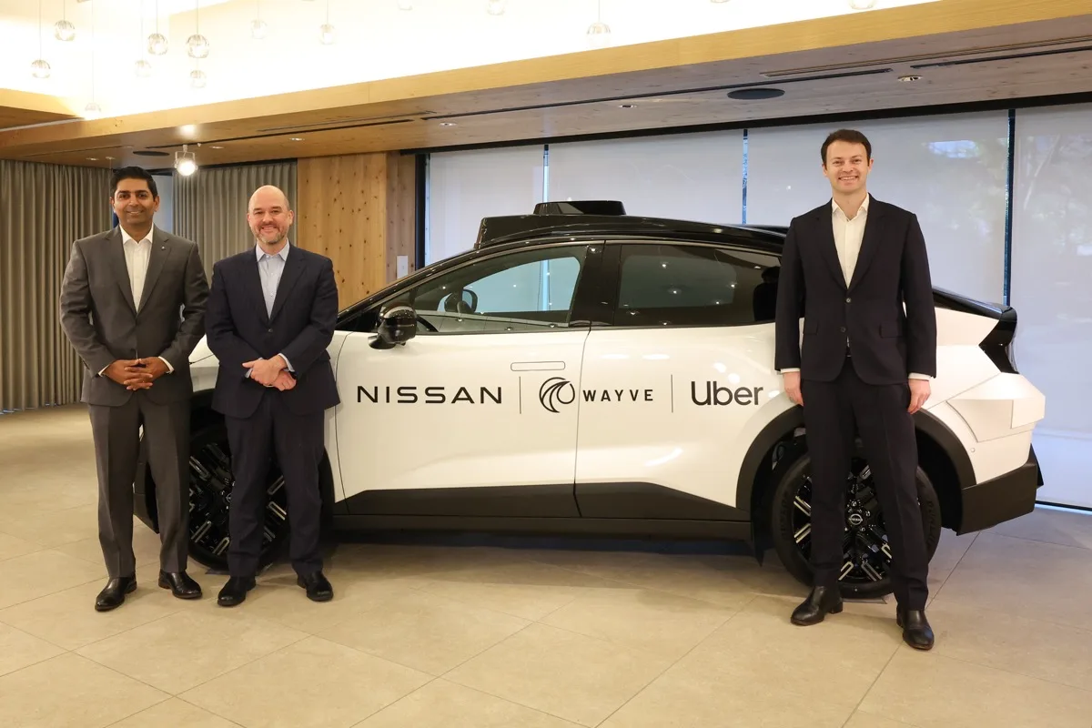 Wayve Uber and Nissan executives pose with Nissan LEAF robotaxi at Tokyo announcement