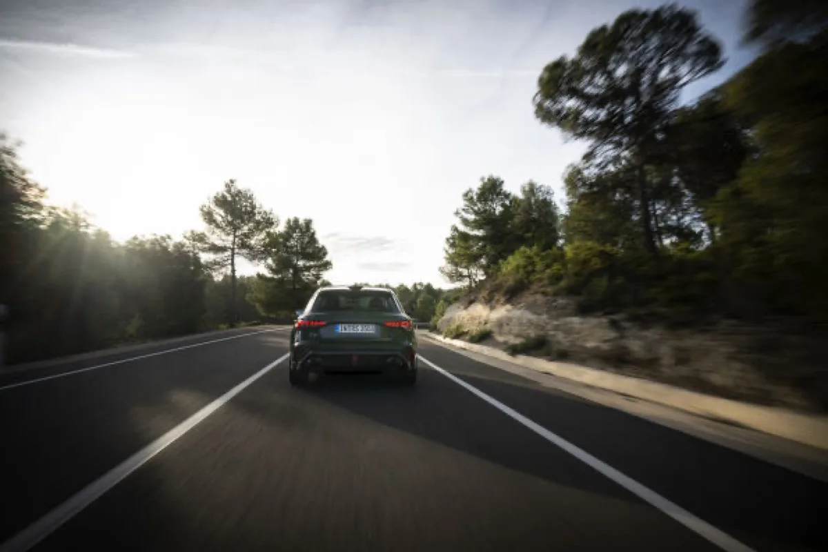 2026 Audi RS 3 competition limited Sportback in Malachite green, direct rear view showing full-width OLED tail lights and dual exhaust