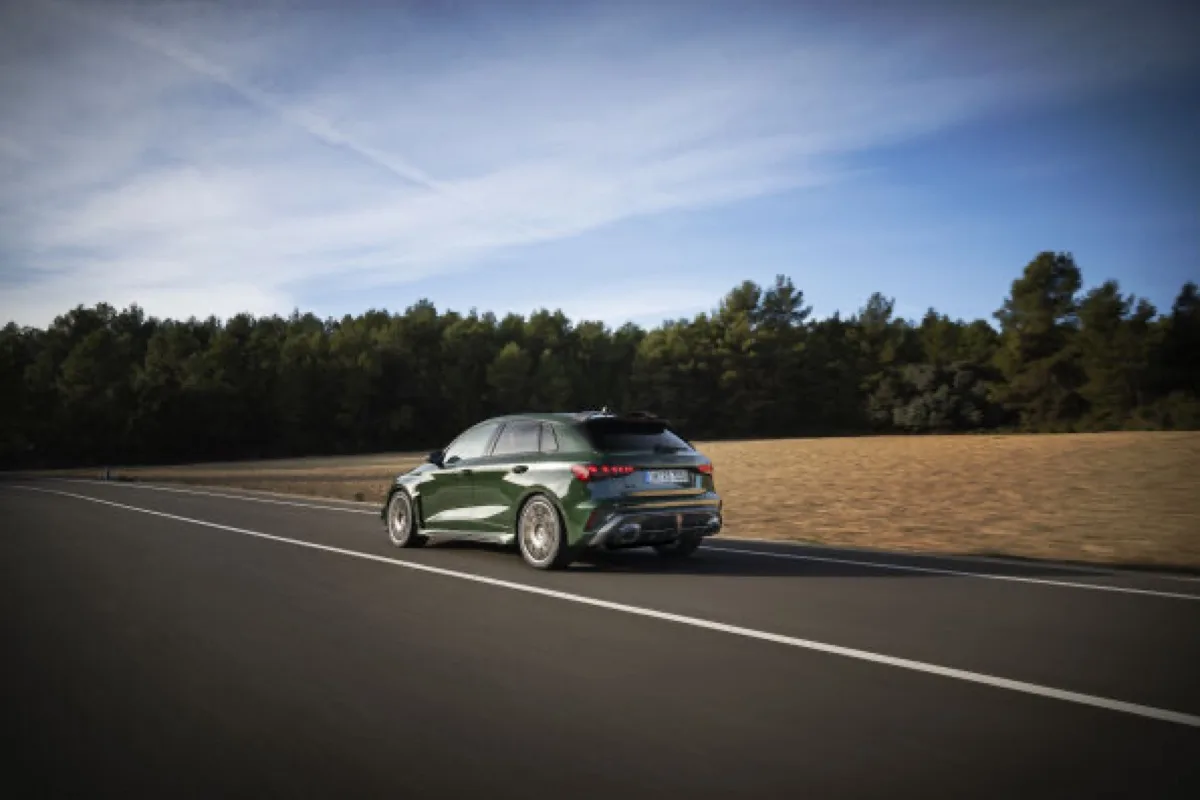2026 Audi RS 3 competition limited Sportback in Malachite green, rolling rear three-quarter view showing rear diffuser and exhaust