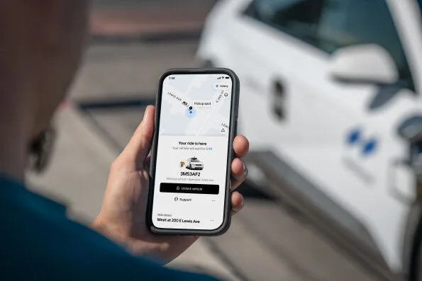 Uber app showing robotaxi arrival with unlock button and Motional IONIQ 5 in background