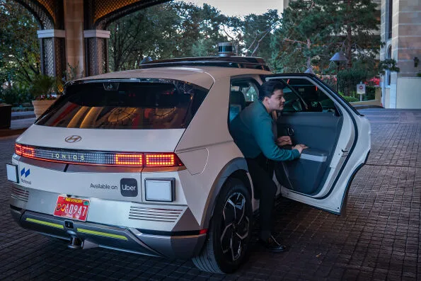 Passenger exiting Motional IONIQ 5 robotaxi at Las Vegas hotel entrance