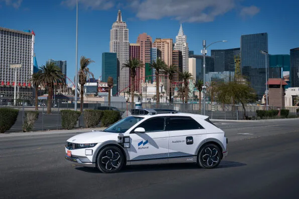 Motional IONIQ 5 robotaxi driving on Las Vegas Boulevard with New York-New York hotel in background