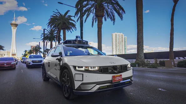 Motional IONIQ 5 robotaxi front view with Stratosphere Tower Las Vegas in background