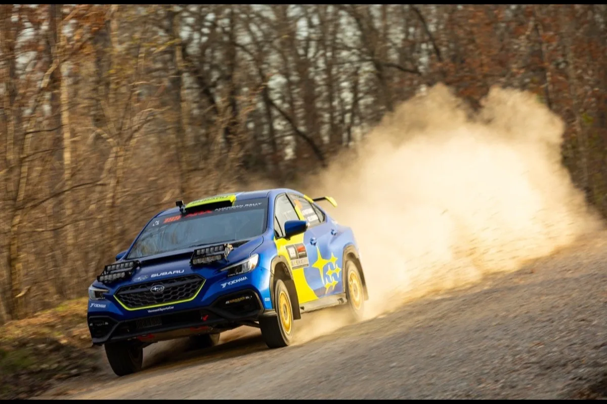 Subaru Motorsports USA WRX rally car kicking up dust on gravel stage