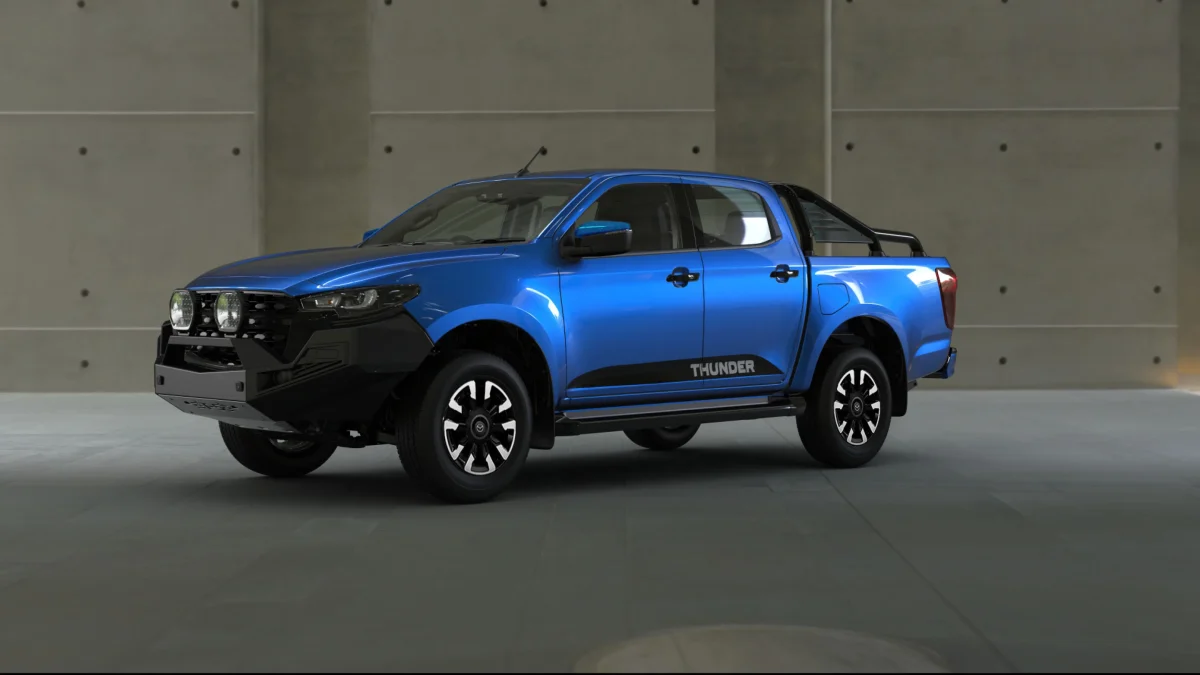2026 Mazda BT-50 Thunder dual cab ute front three-quarter view in blue with bull bar and Lightforce driving lights