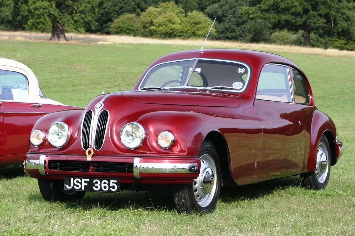 Bristol 401 in burgundy at classic car show on grass