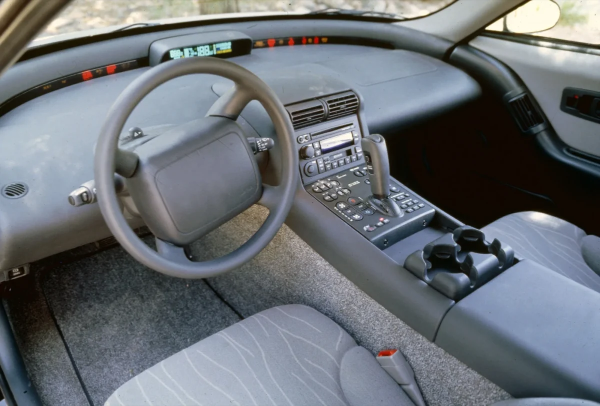 GM EV1 interior showing digital instrument cluster dashboard center console and gray cloth seats