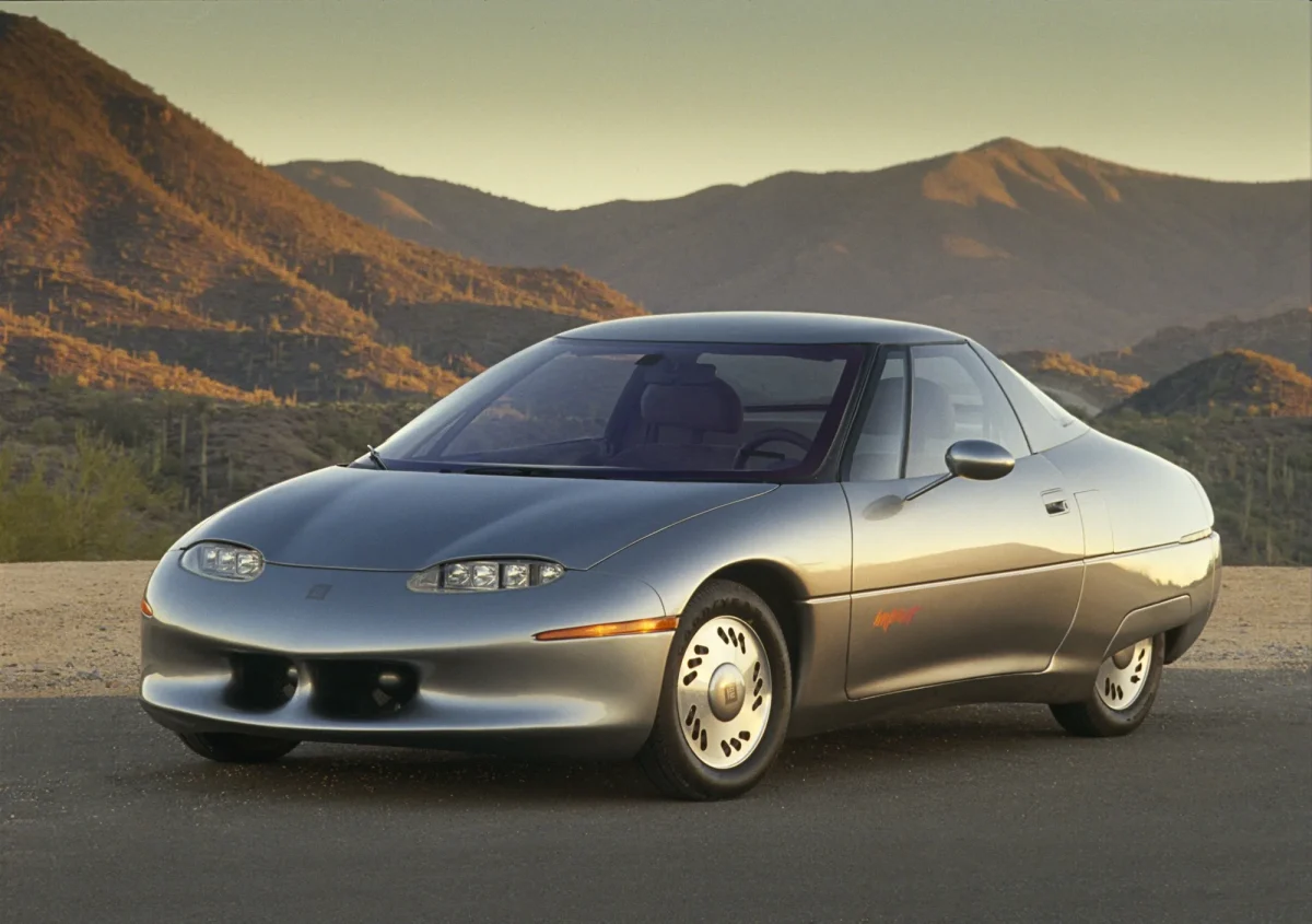 1990 GM Impact concept car silver in desert setting precursor to the EV1