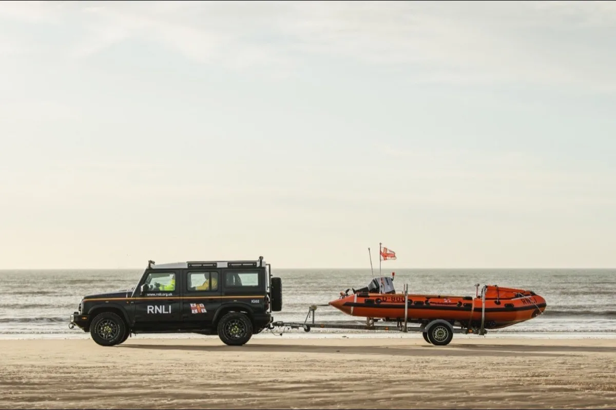 INEOS Grenadier towing RNLI lifeboat trailer on beach