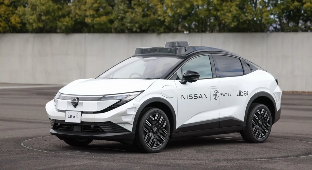 Nissan LEAF robotaxi with Wayve AI Driver and Uber branding front three-quarter view