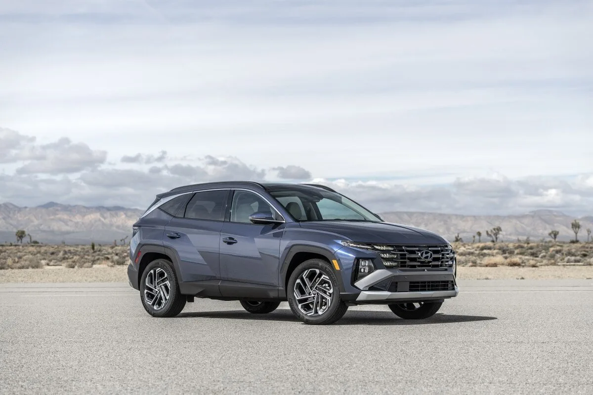 2026 Hyundai Tucson in grey front three-quarter view in desert landscape
