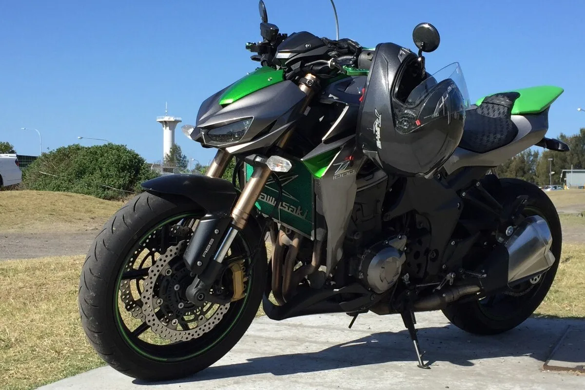 Kawasaki Z1000 in green and grey front three-quarter view on concrete
