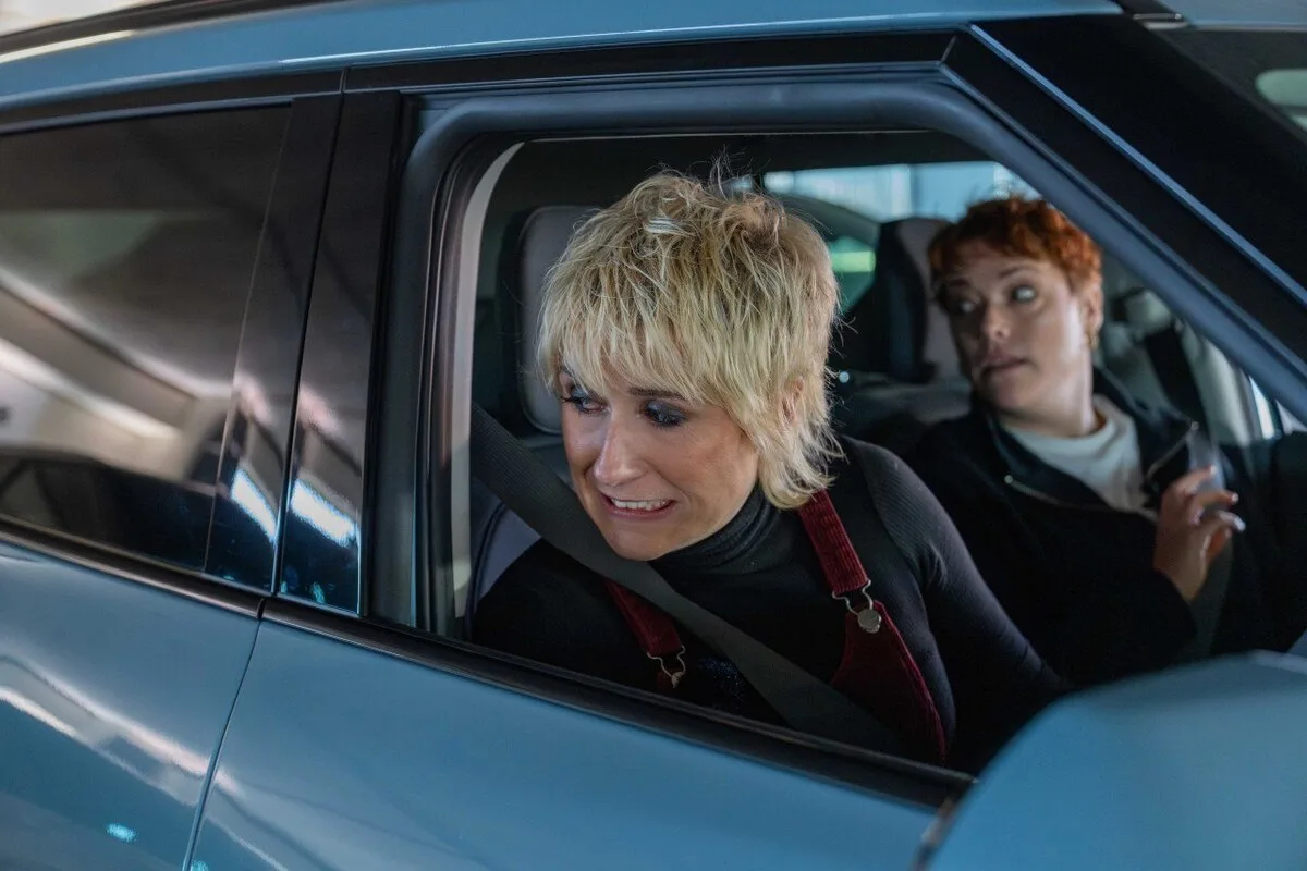 Maisie Adam looking nervous in Kia EV2 with parking instructor Francesca Reid