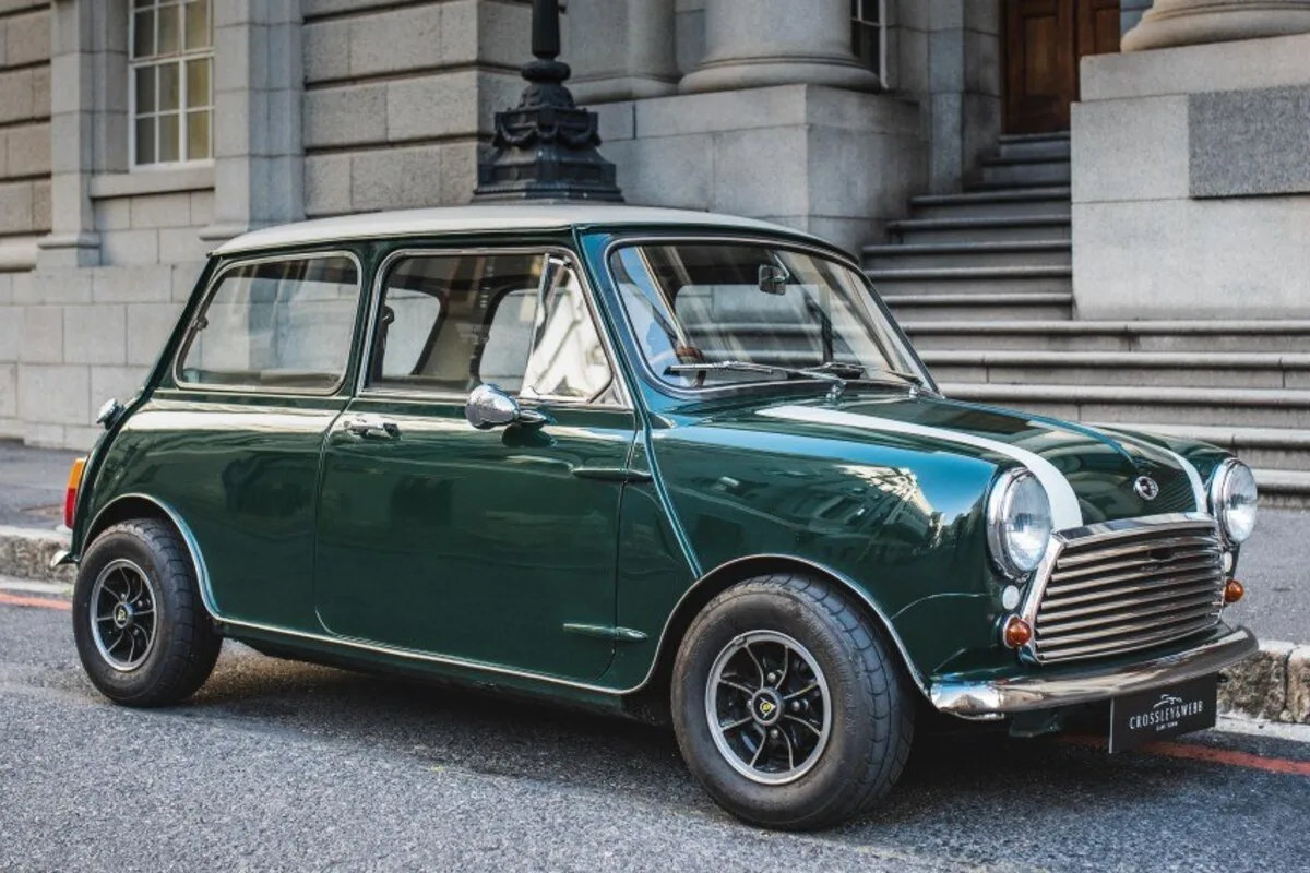 Classic British Racing Green Mini Cooper S with white roof outside grand building