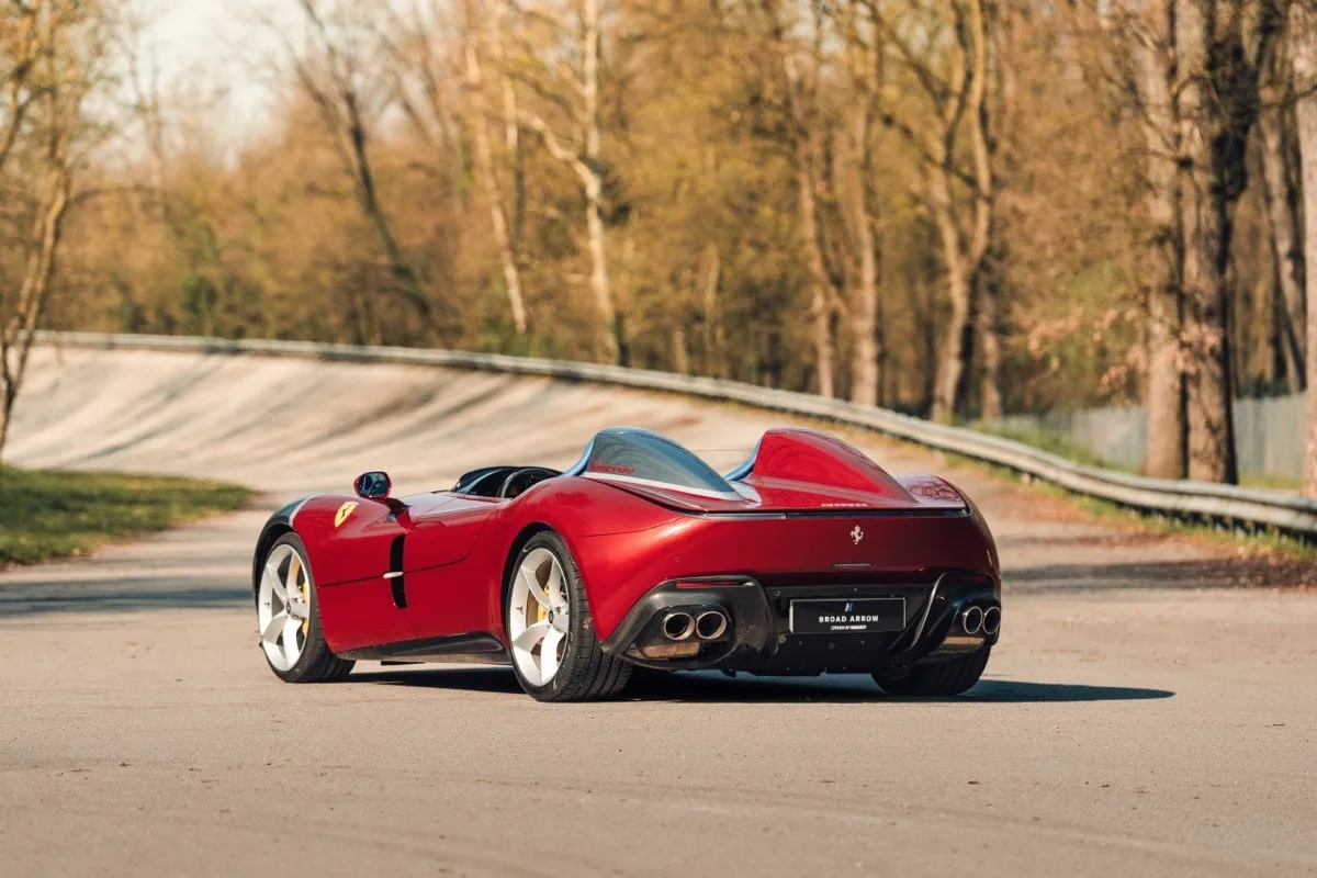 Ferrari Monza SP2 static rear three-quarter showing twin exhausts, rear cowl, and Argento Nurburgring wheels