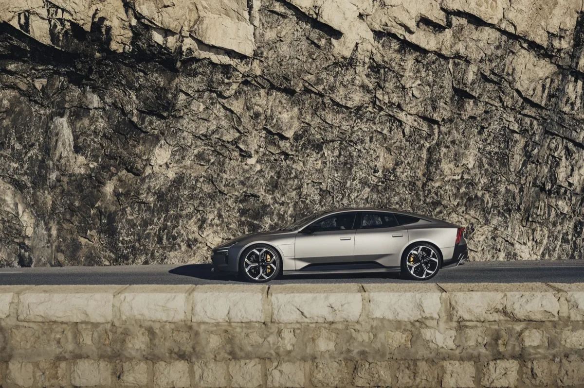 Polestar 5 side profile positioned against dramatic exposed rock face