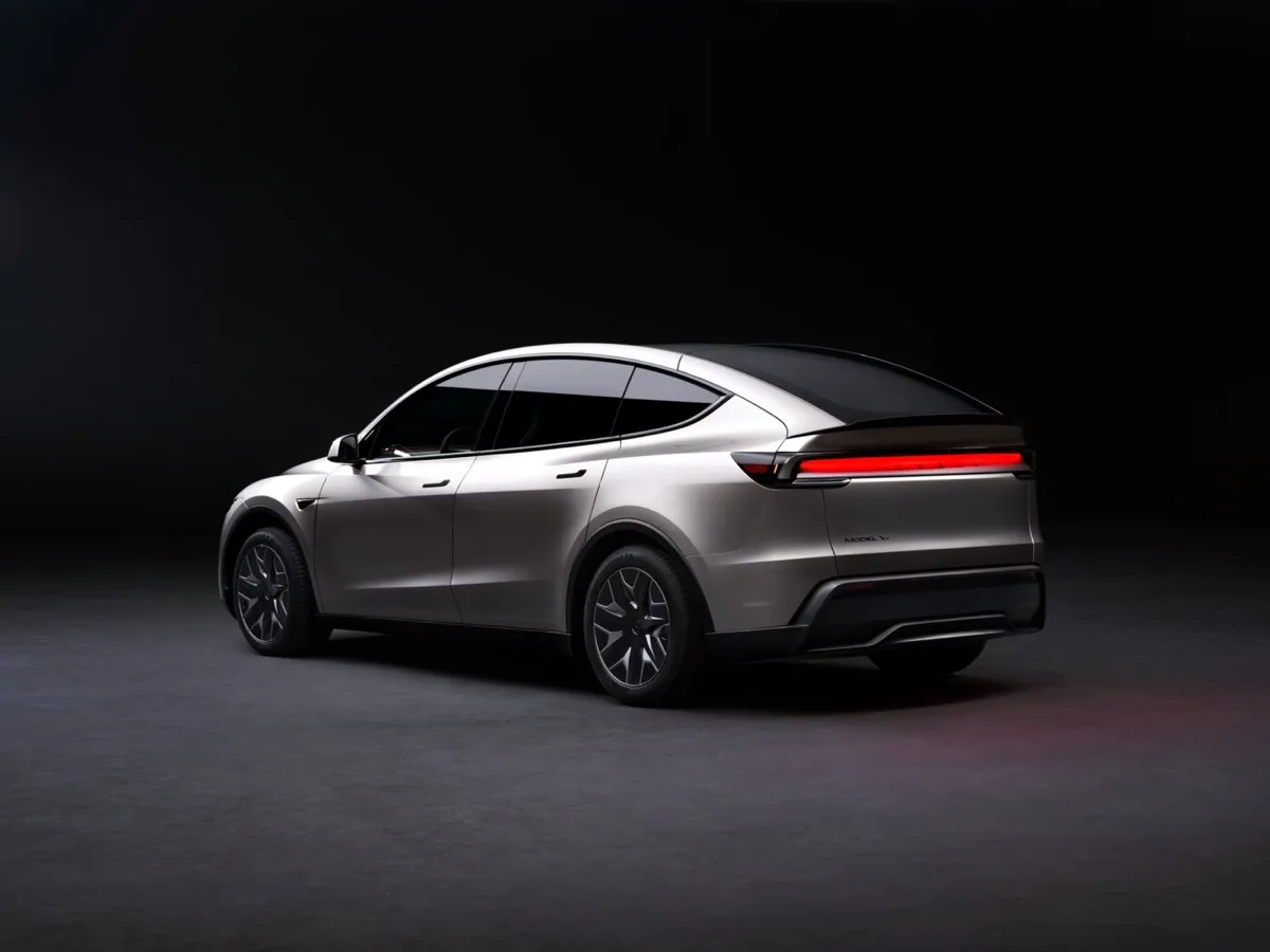 Tesla Model Y L rear three-quarter view showing full-width LED tail light bar