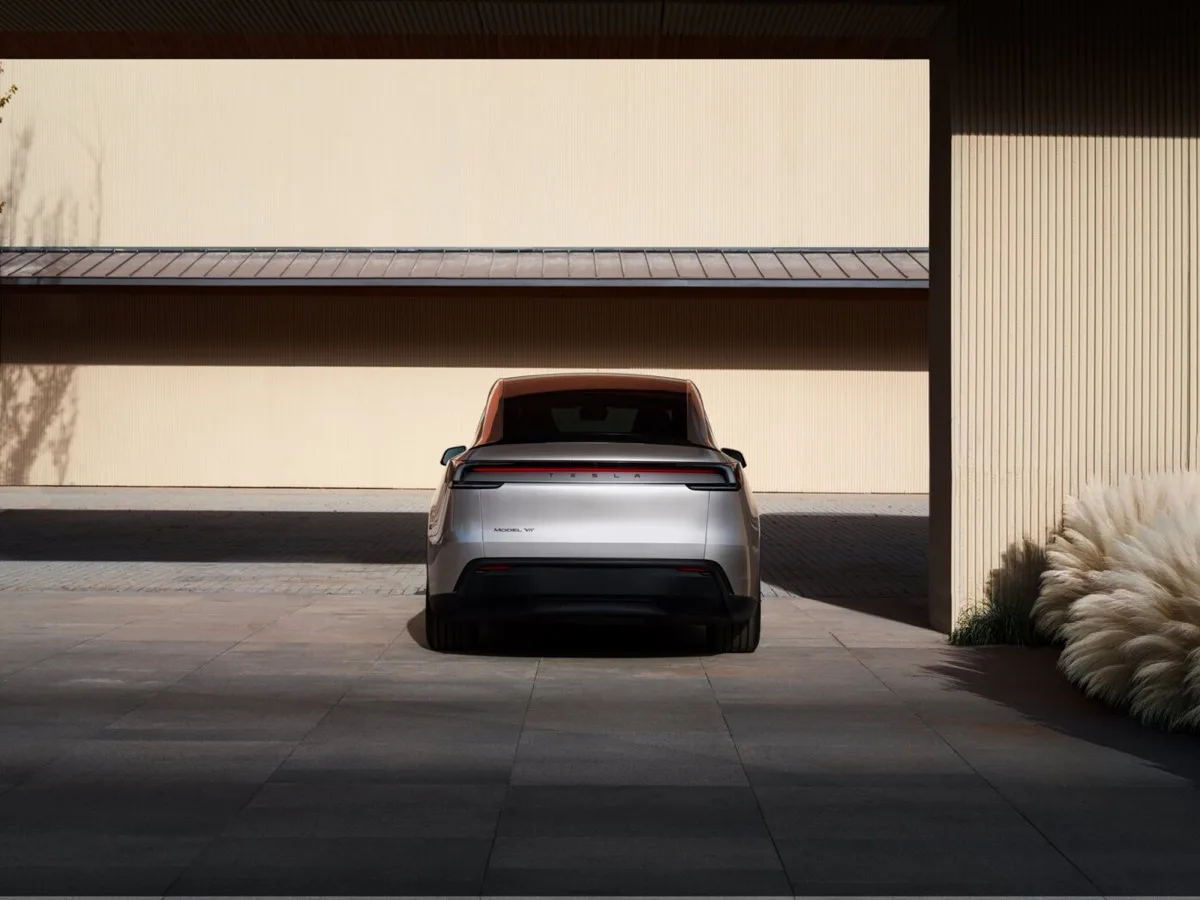 Tesla Model Y L dead-on rear view showing Tesla badging and full-width tail light