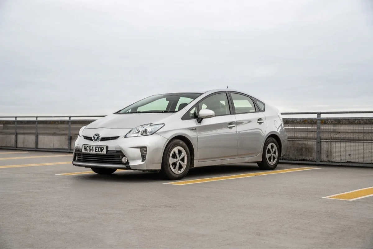 2014 Toyota Prius high-mileage hybrid parked for eBay used car mileage story