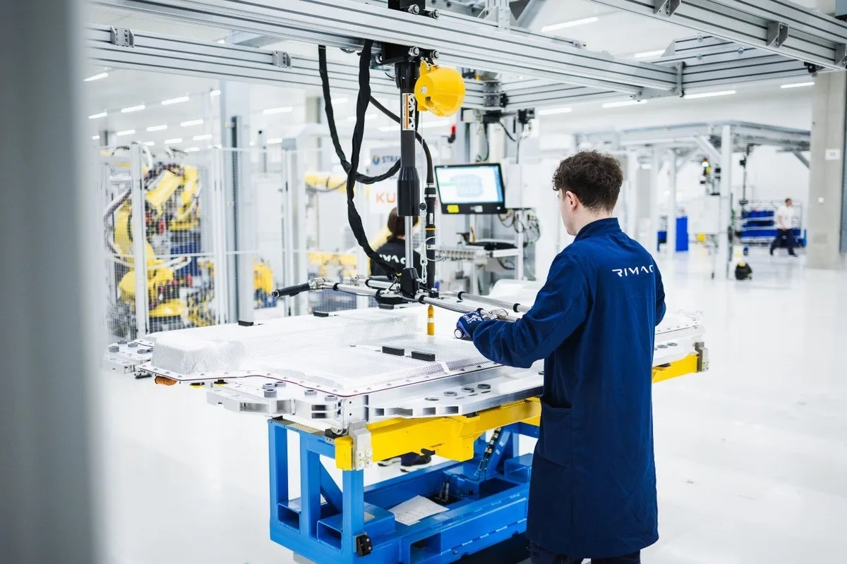 Rimac engineer handling BMW i7 battery pack assembly in 2026