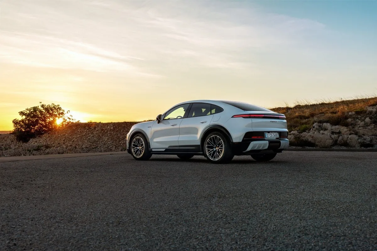 2026 Porsche Cayenne Coupe Electric rear three-quarter view at sunset