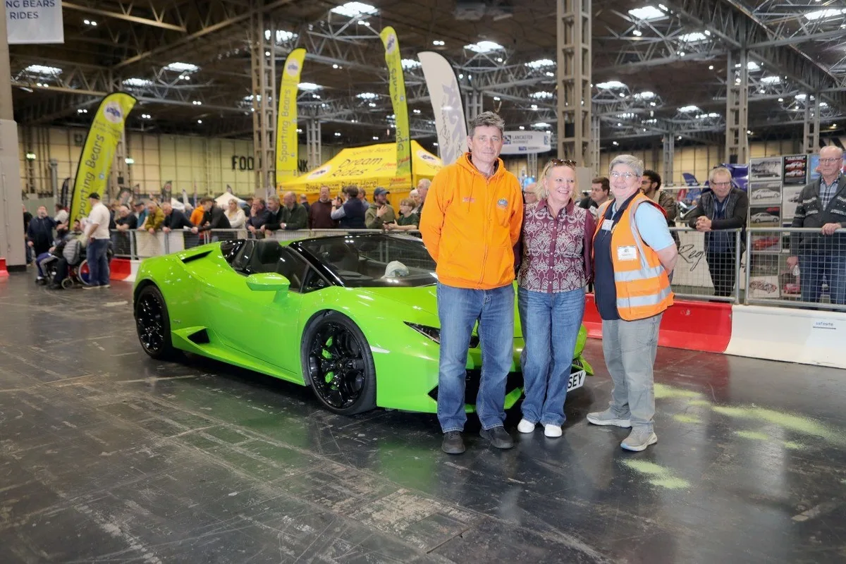 Sporting Bears members beside green supercar at charity event in 2026