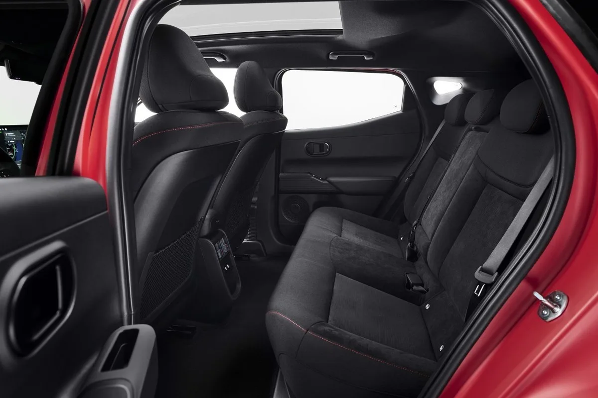 2027 Hyundai IONIQ 3 rear seat space with dark upholstery and panoramic roof