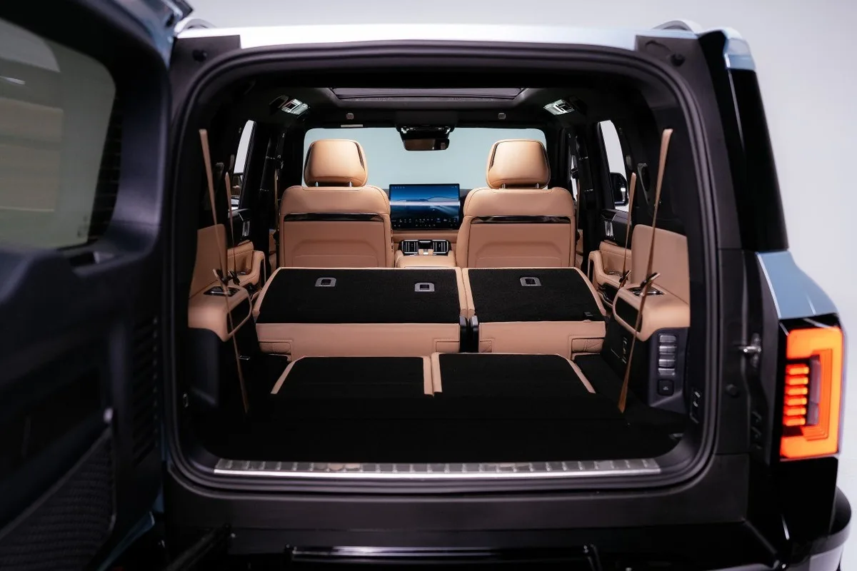 Denza B8 cargo area with the rear seats folded flat and the tailgate open