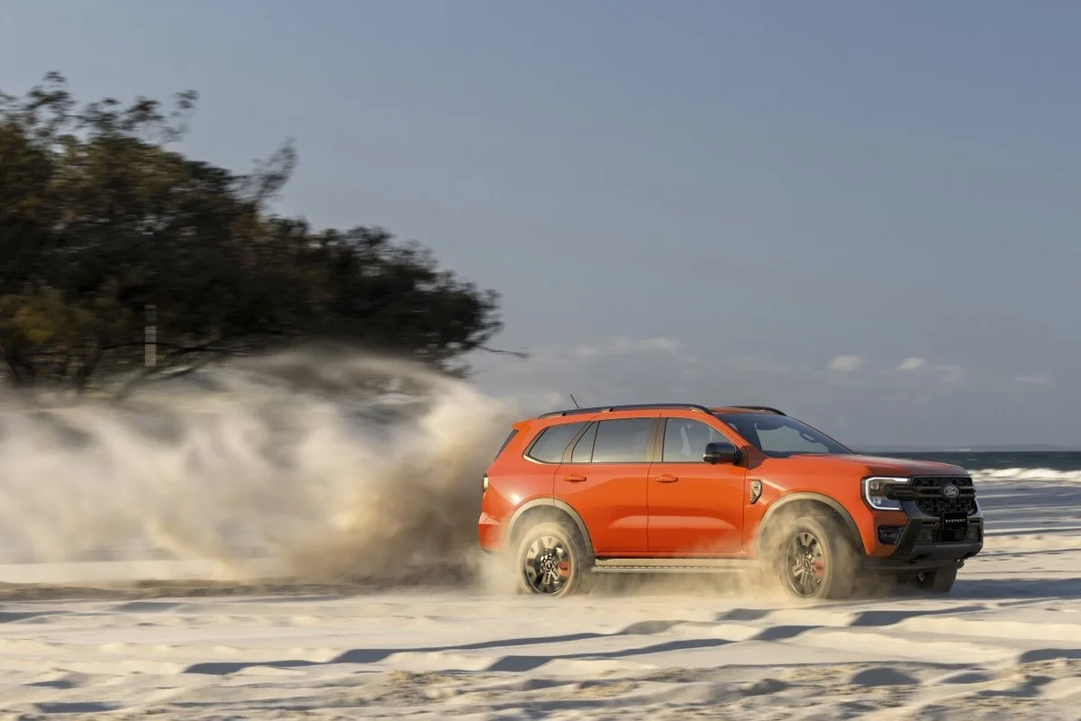 Ford Everest Wildtrak driving across sand near the beach