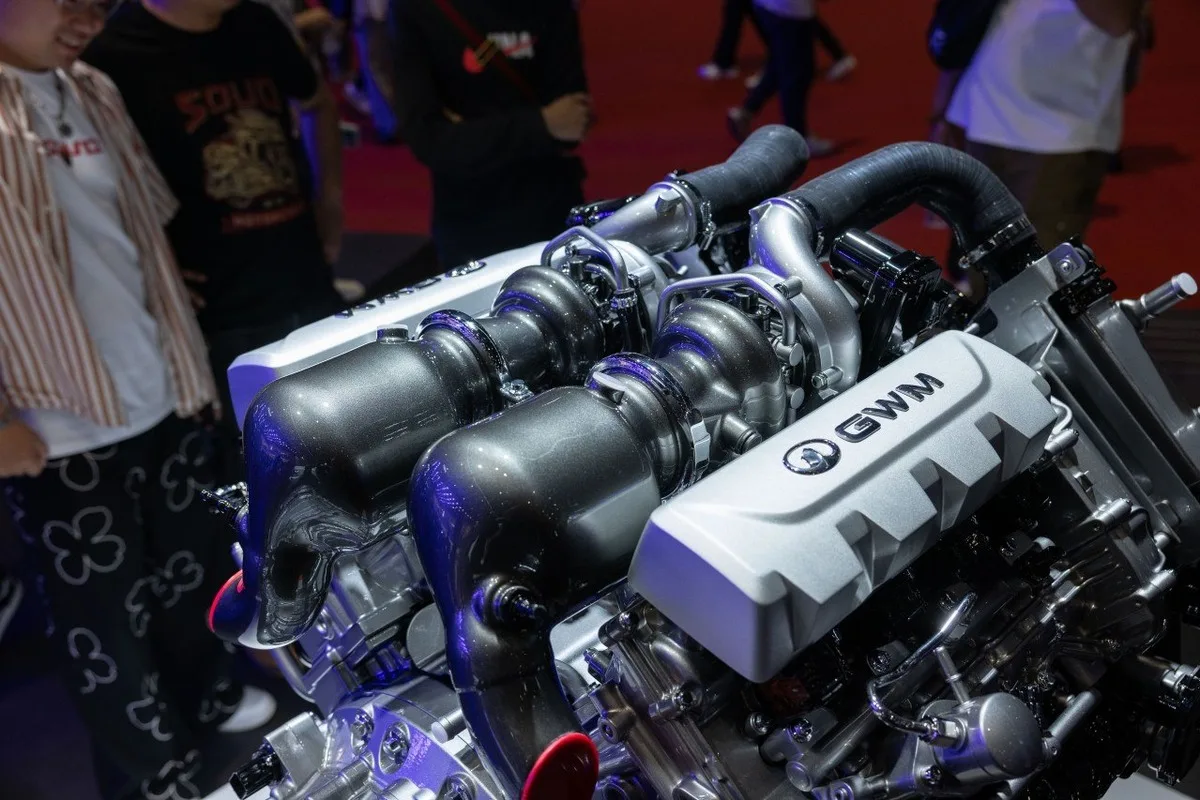 Close view of a GWM engine display with black intake piping and silver covers