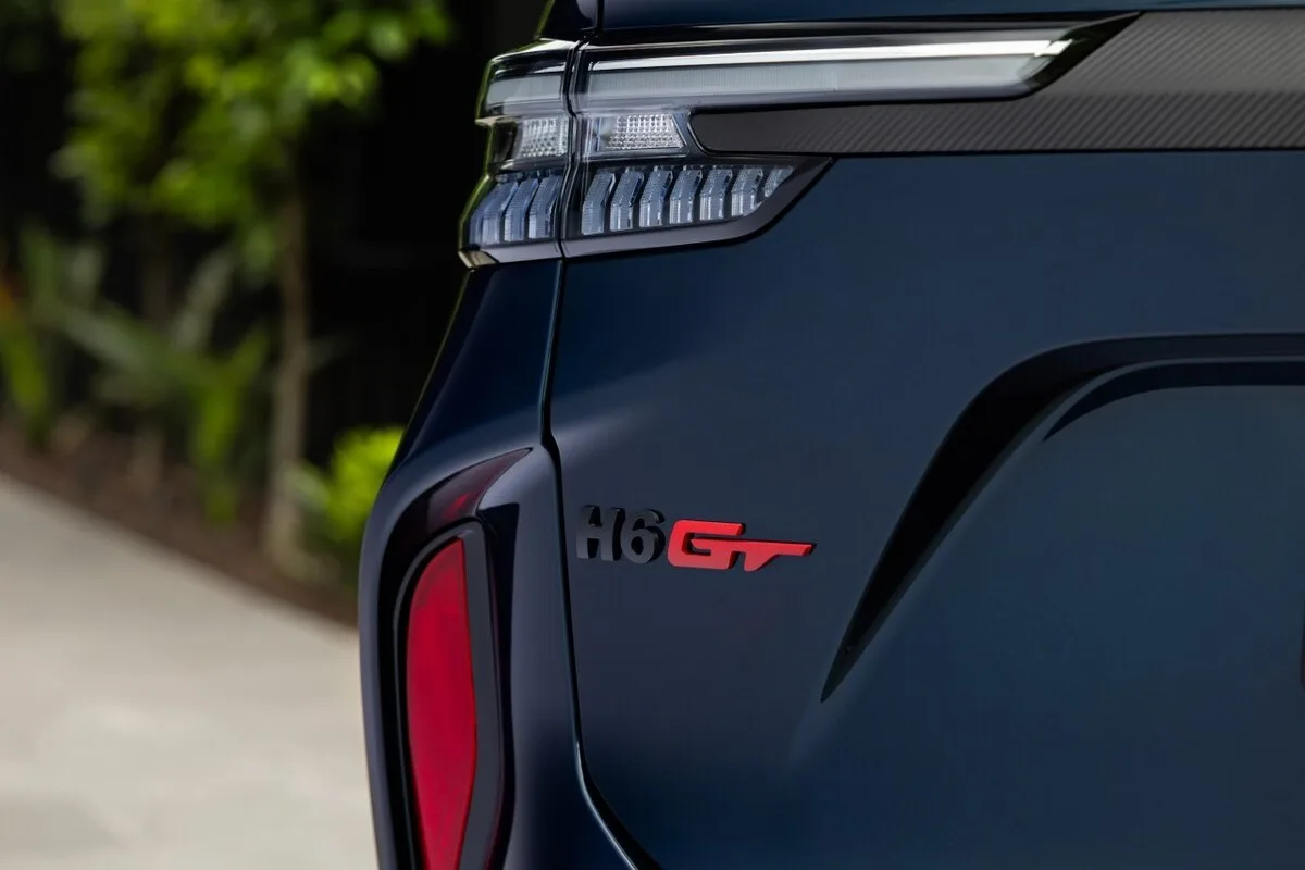 Close-up of the rear badge and taillight on a dark GWM H6 GT SUV