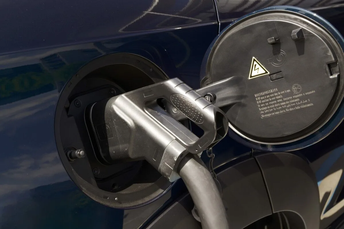 Close-up of a GWM vehicle charging port with EV charging cable plugged in