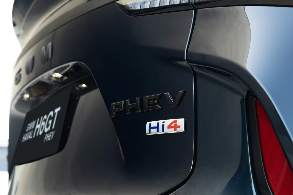 Close-up of GWM vehicle rear showing PHEV and Hi4 badges on the tailgate