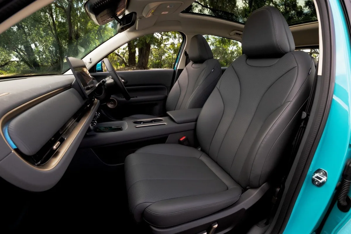 2026 GWM ORA 5 front cabin viewed from the passenger side with black seats, touchscreen, and panoramic roof