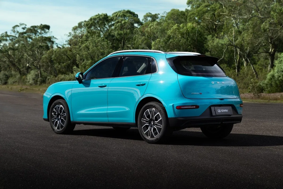 2026 GWM ORA 5 in turquoise shown from a rear three quarter angle with tinted glass and alloy wheels