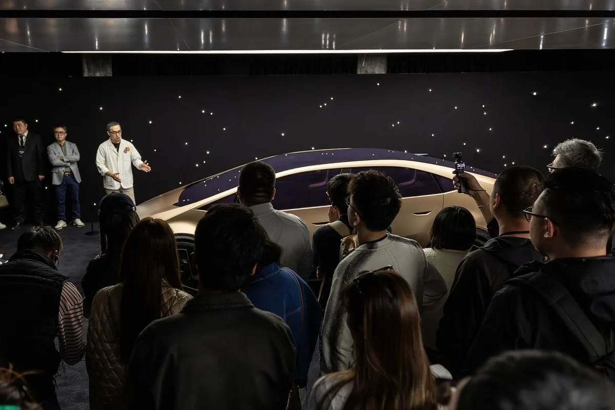 Audience at the Hyundai IONIQ China launch watching the champagne gold VENUS concept during a reveal presentation