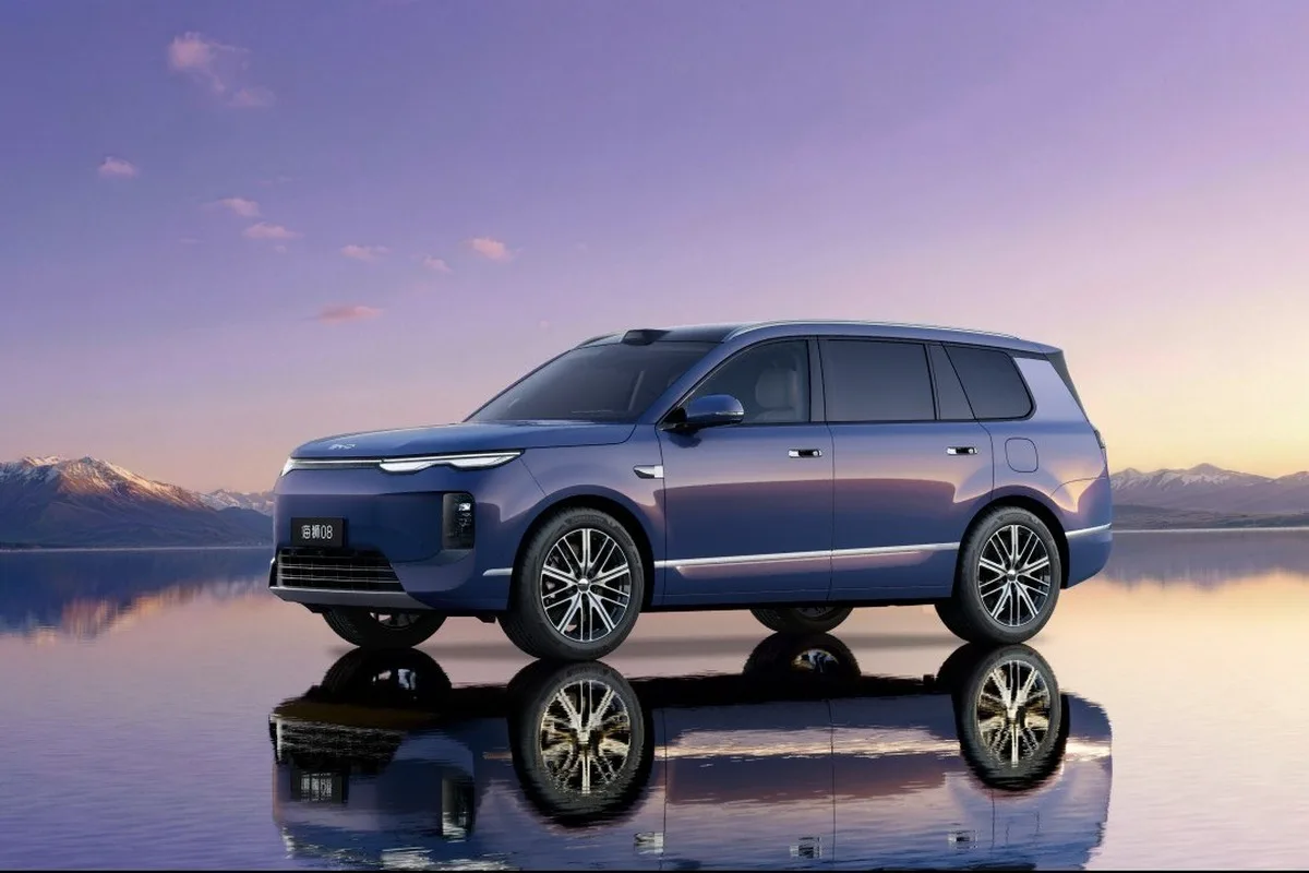BYD SEALION 08 blue purple electric SUV on a reflective surface by mountains