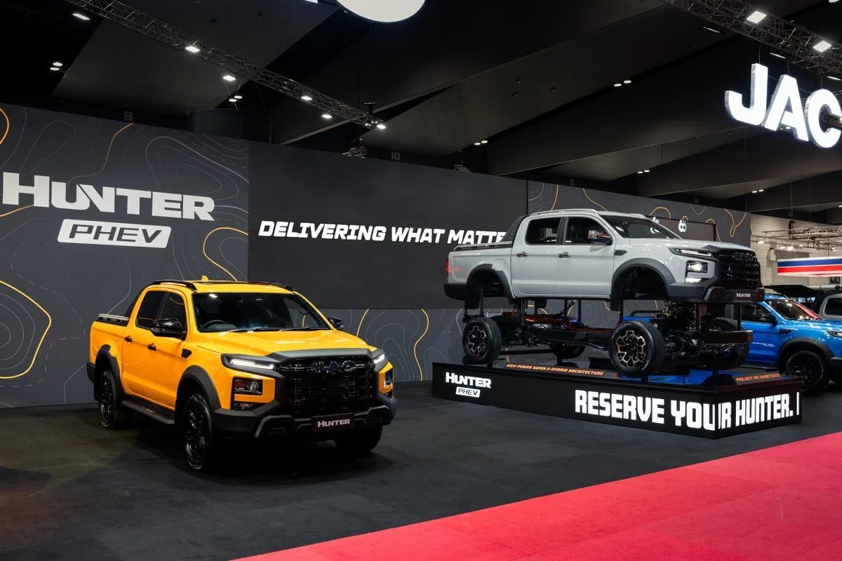 2026 JAC Hunter PHEV display stand at the Melbourne Motor Show with yellow and white ute exhibits