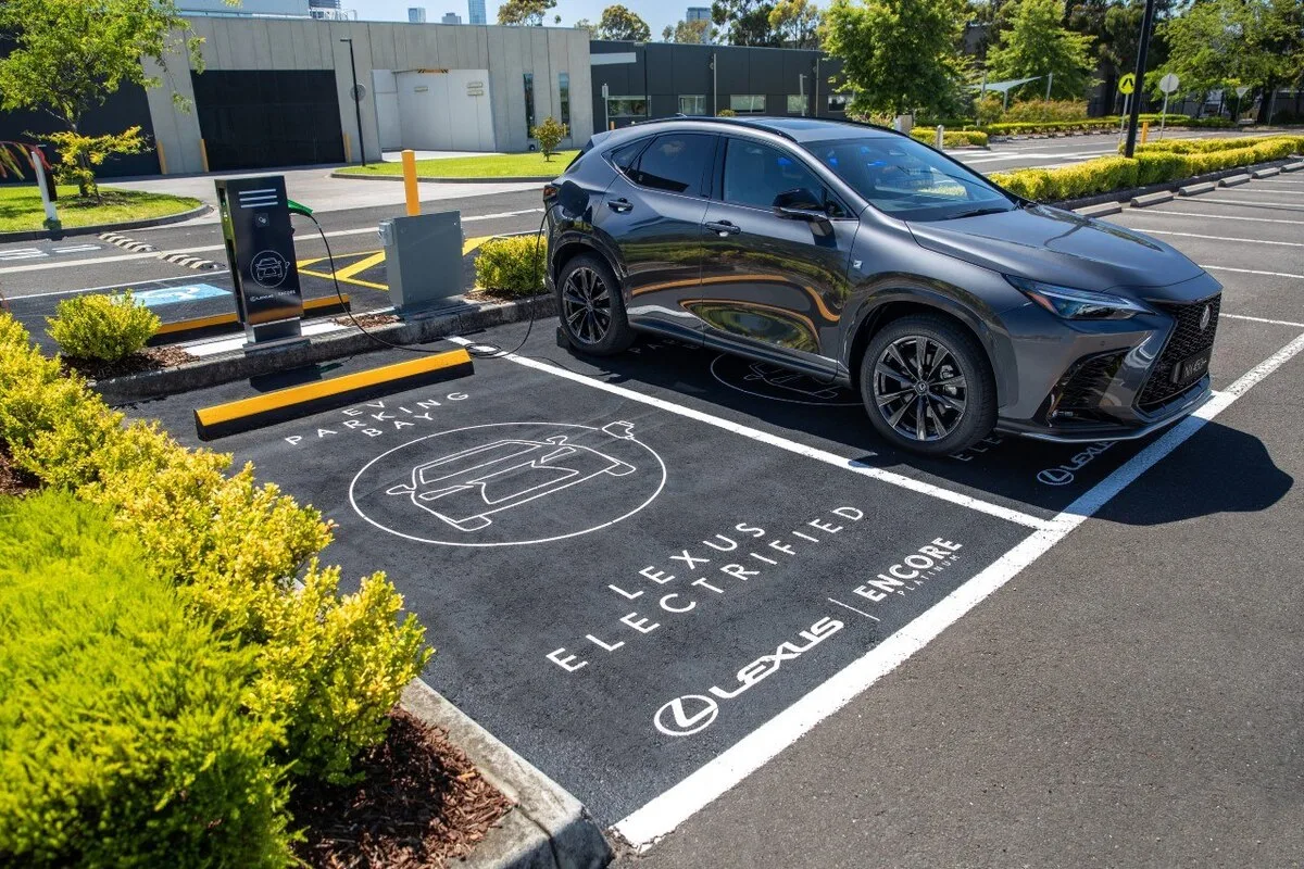 Grey Lexus NX parked and charging in a branded Lexus Electrified parking bay