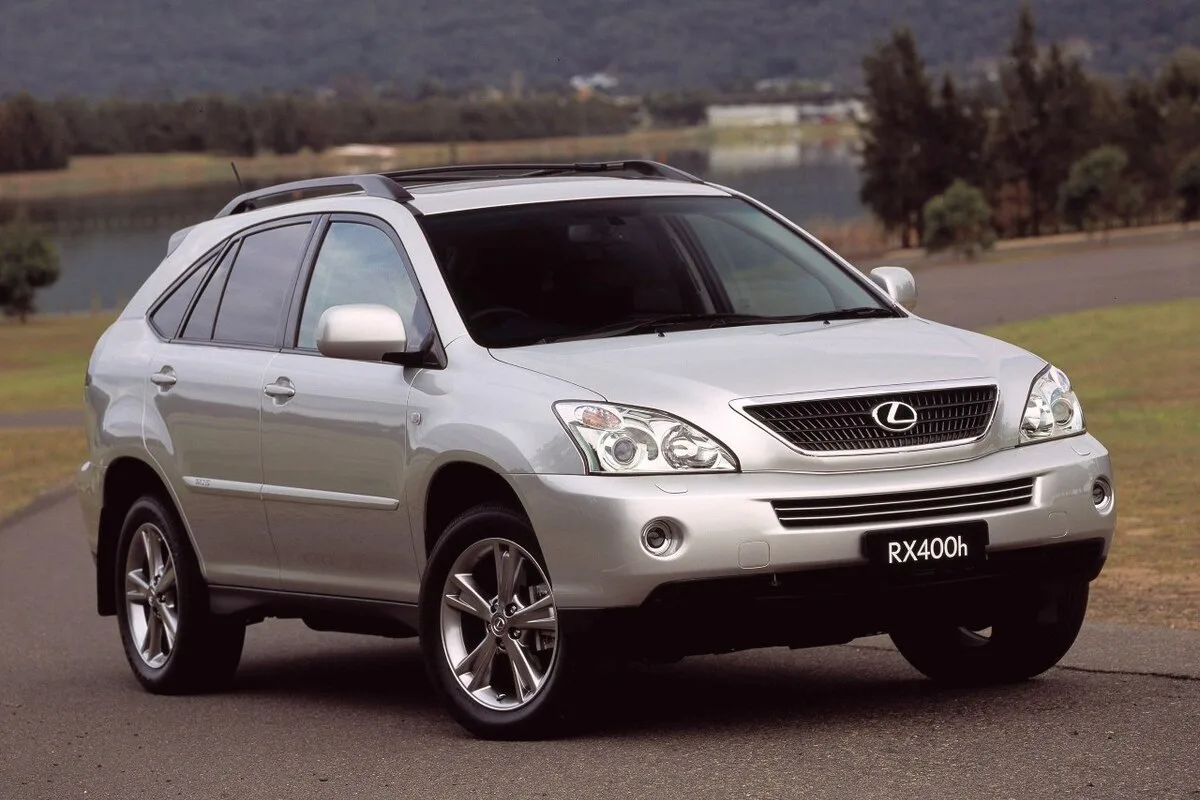 Silver Lexus RX400h luxury hybrid SUV shown from the front three-quarter angle on a paved road outdoors.