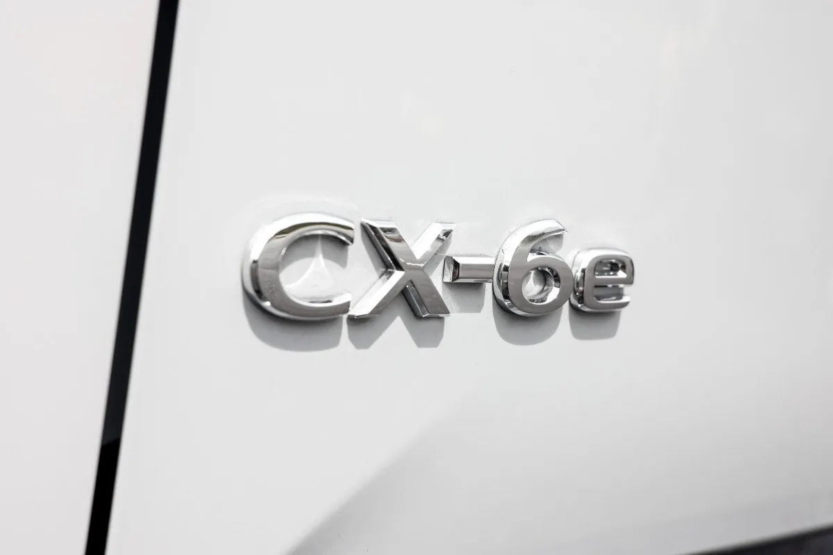 Mazda CX-6e red exterior press image showing side profile styling