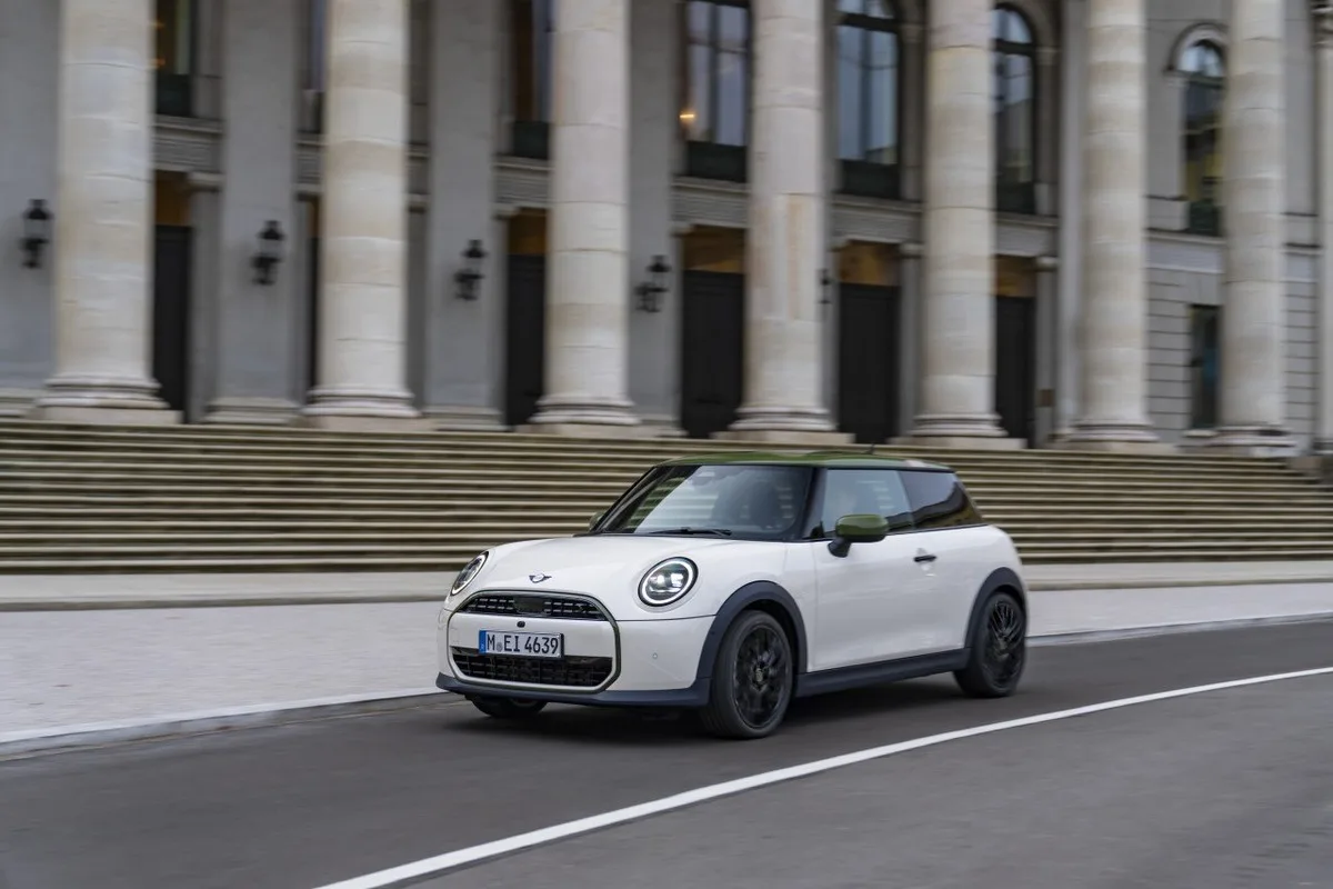 MINI Cooper driving past monumental city architecture