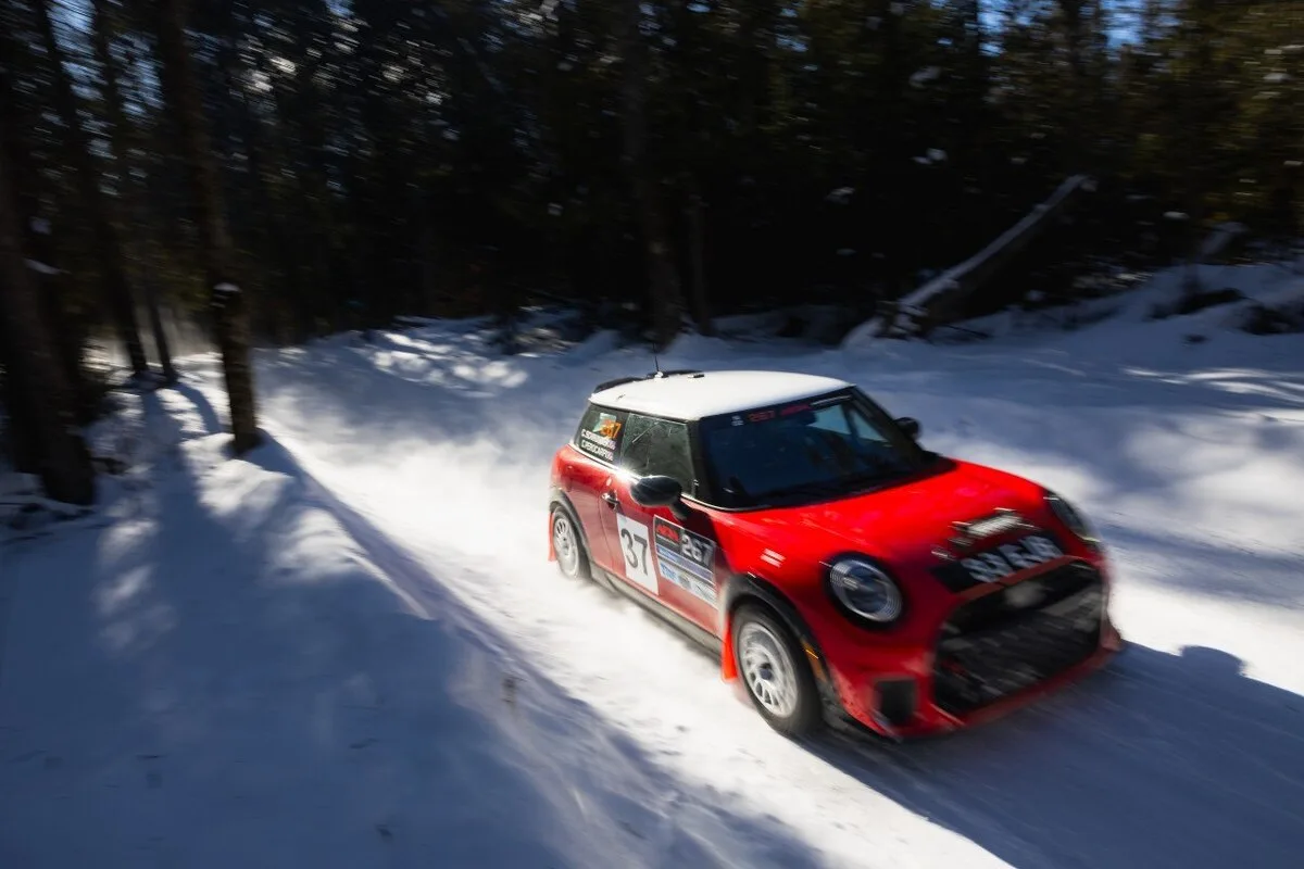 2026 MINI USA red MINI Cooper race car number 37 on a snowy forest stage during American Rally Association competition