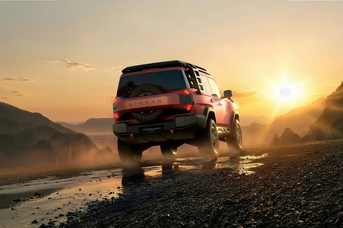 Nissan Terrano PHEV Concept driving through rough terrain at sunset in rear view