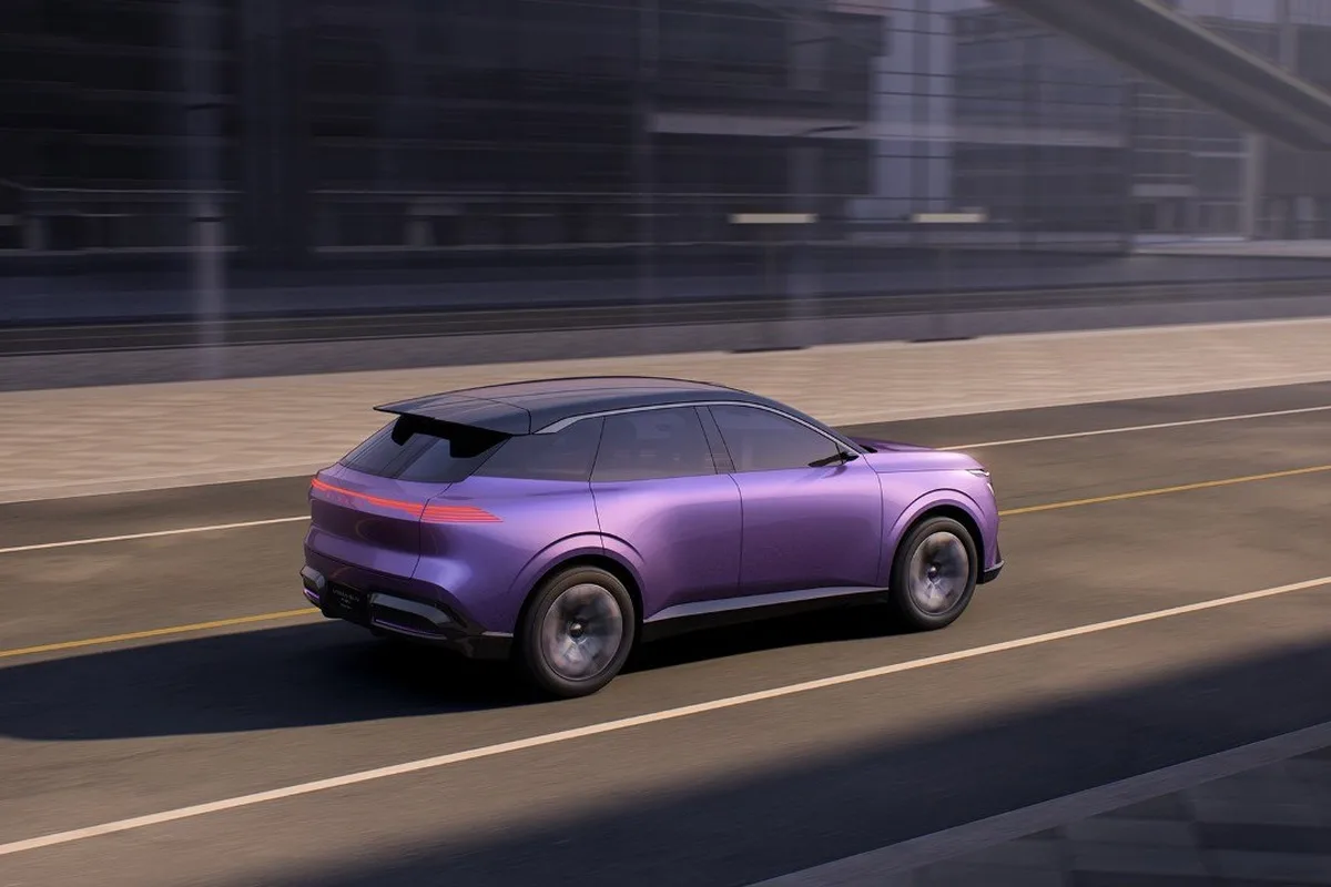 Nissan Urban SUV Concept rear three-quarter view driving through a city street