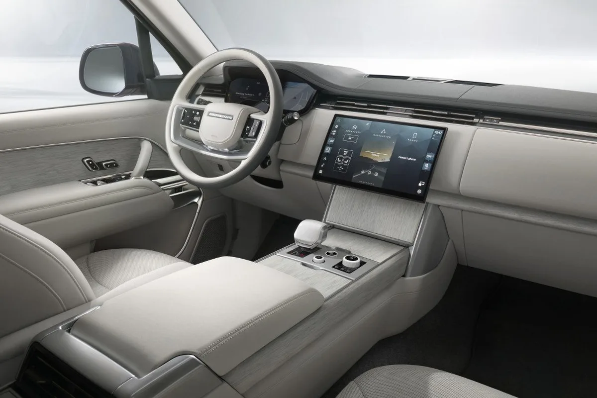 Range Rover SV Ultra front cabin with touchscreen, pale trim, and wood veneer