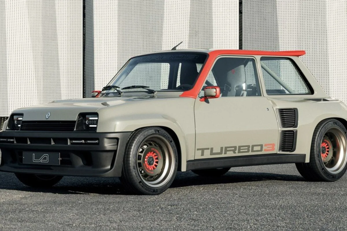 Renault 5 Turbo 3E in grey and red shown from the front three-quarter angle outdoors